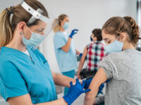 Doctor Vaccinating Girl. Injecting Covid 19 Vaccine Into Patient's Arm